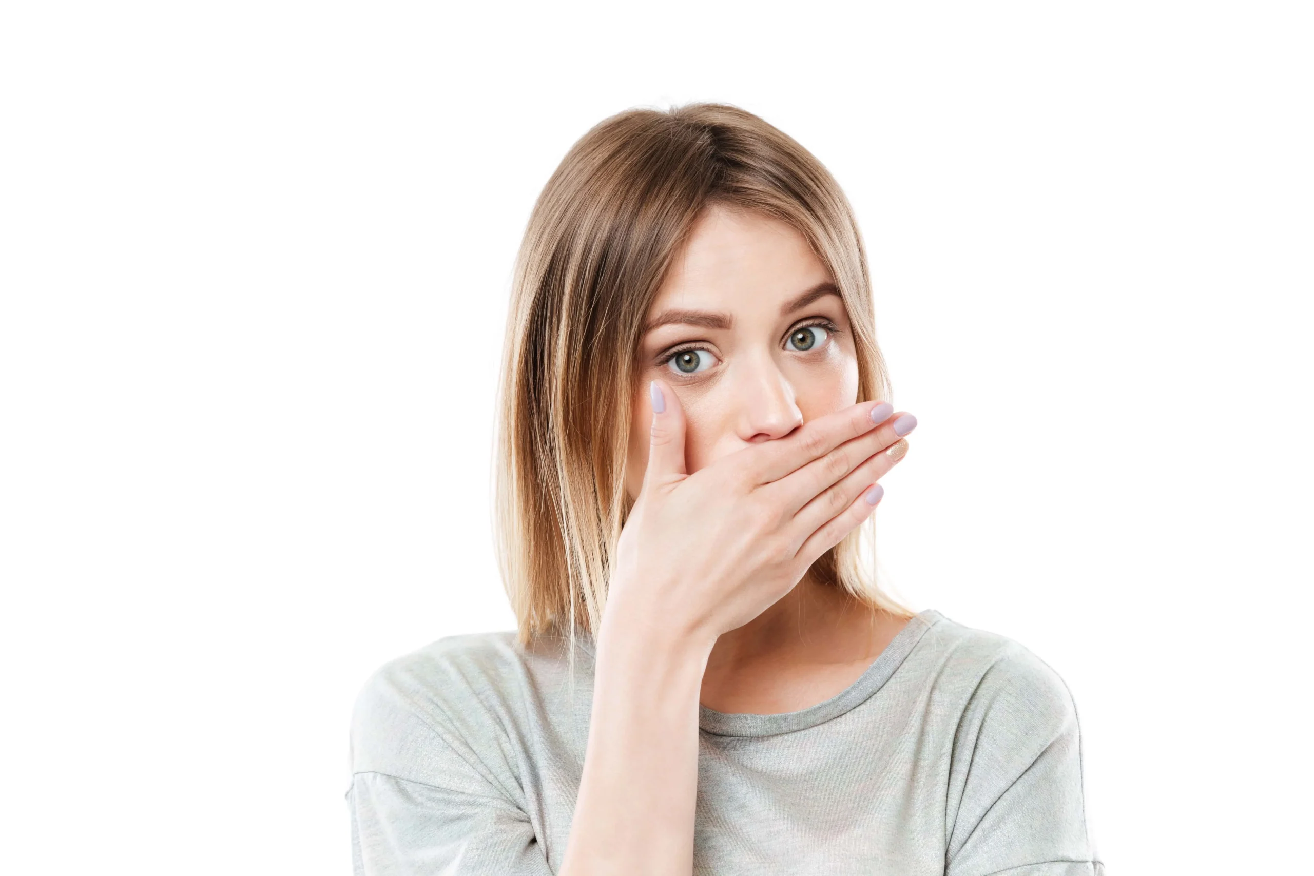 A young woman holding her palm to her face covering her mouth.